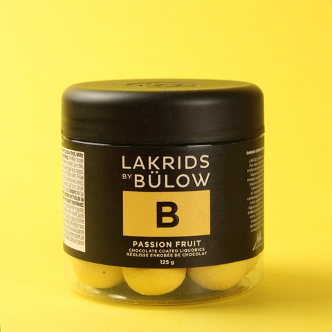 Jar of Lakrids by Bölow passion fruit chocolate on a yellow background