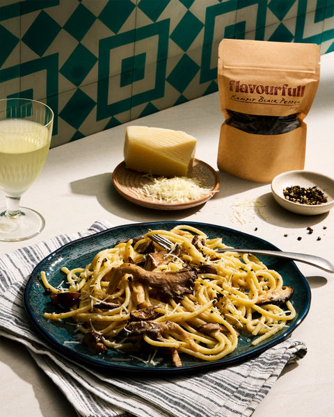 A plate of kampot pepper cacio e pepe with mushrooms